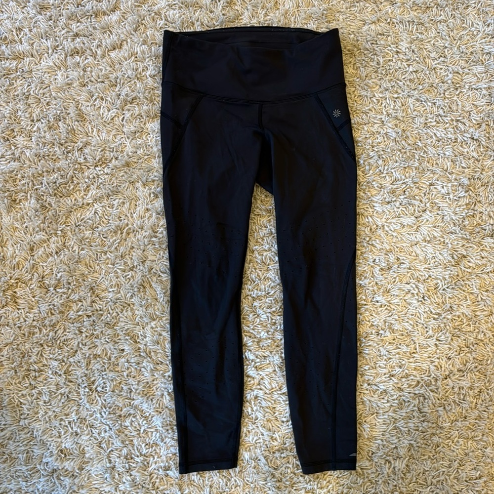 Athleta black leggings with perforated hole design on legs